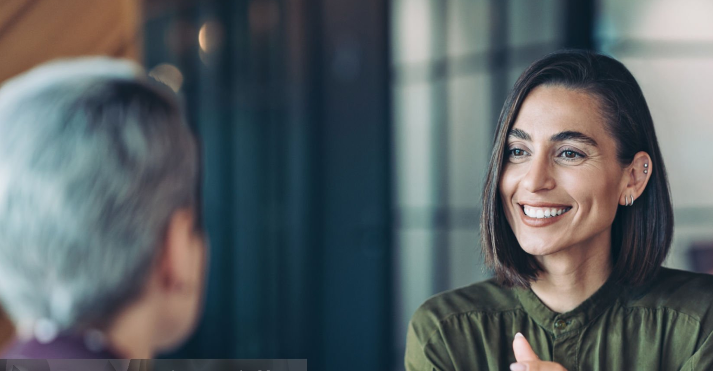 Two people talking and smiling
