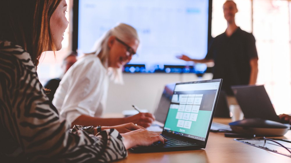 Person taking notes during a presentation