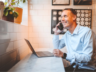 Person smiling and speaking on the phone