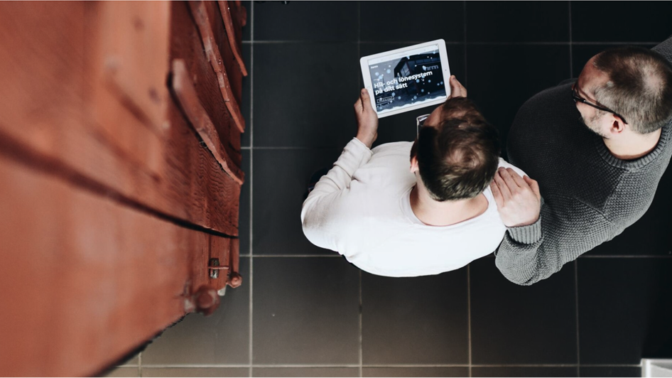 People looking at a tablet
